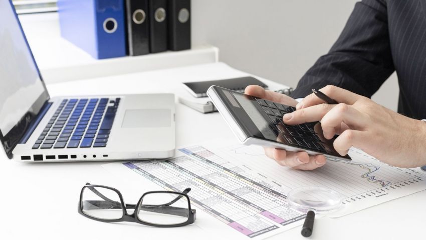 side view business man calculating finance numbers