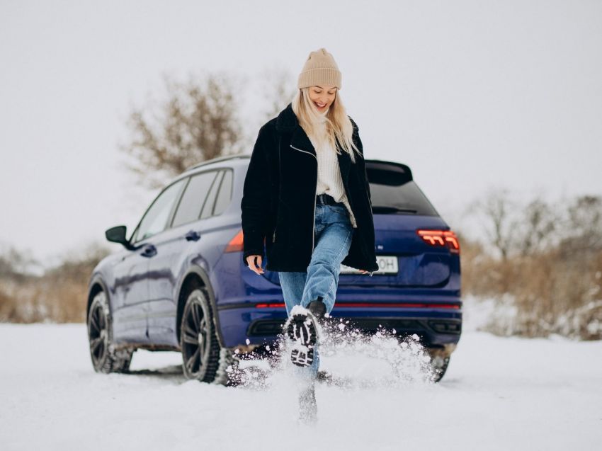 woman standing by her car